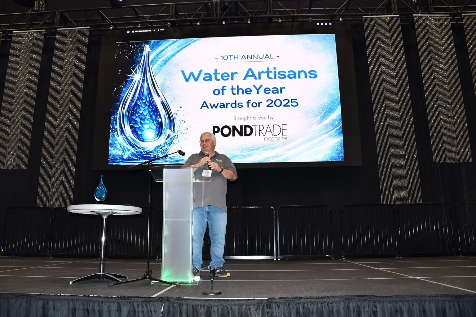 Speaker on stage at a WGE seminar
